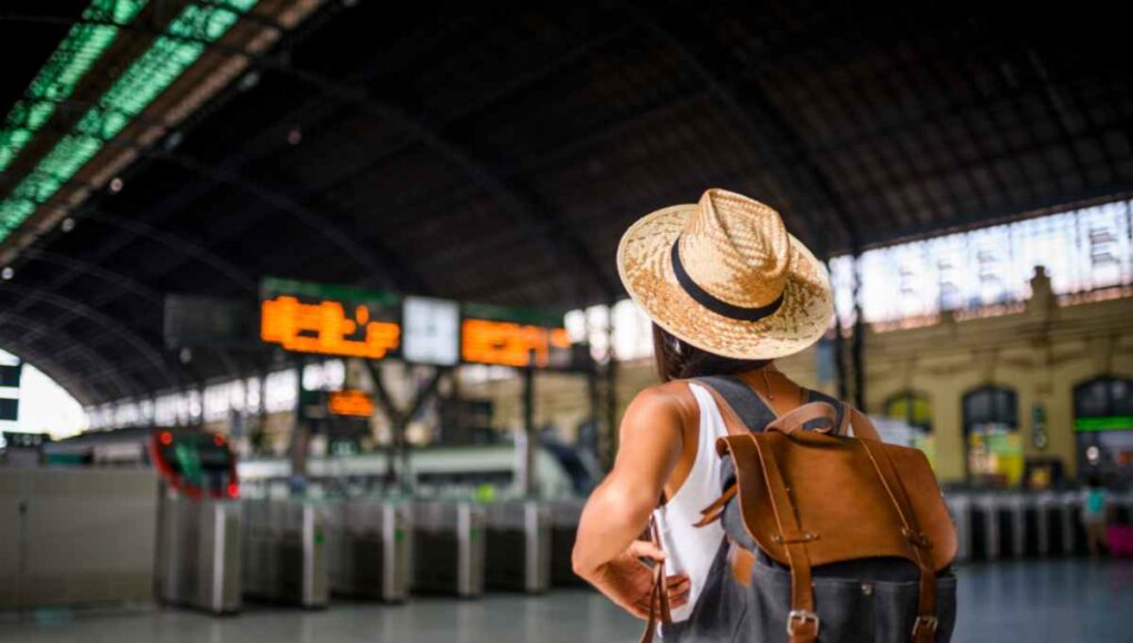 Traveling girl outside train station
